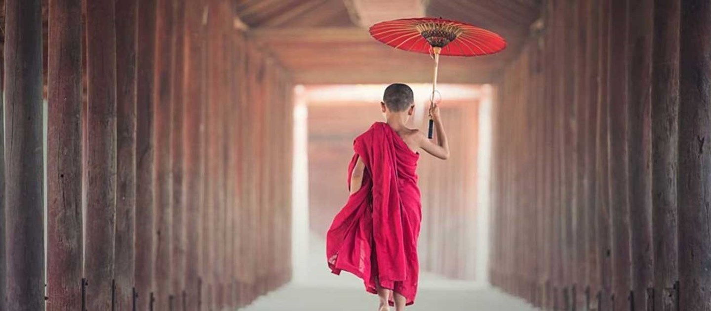 Asia - Boy walking with umbrella